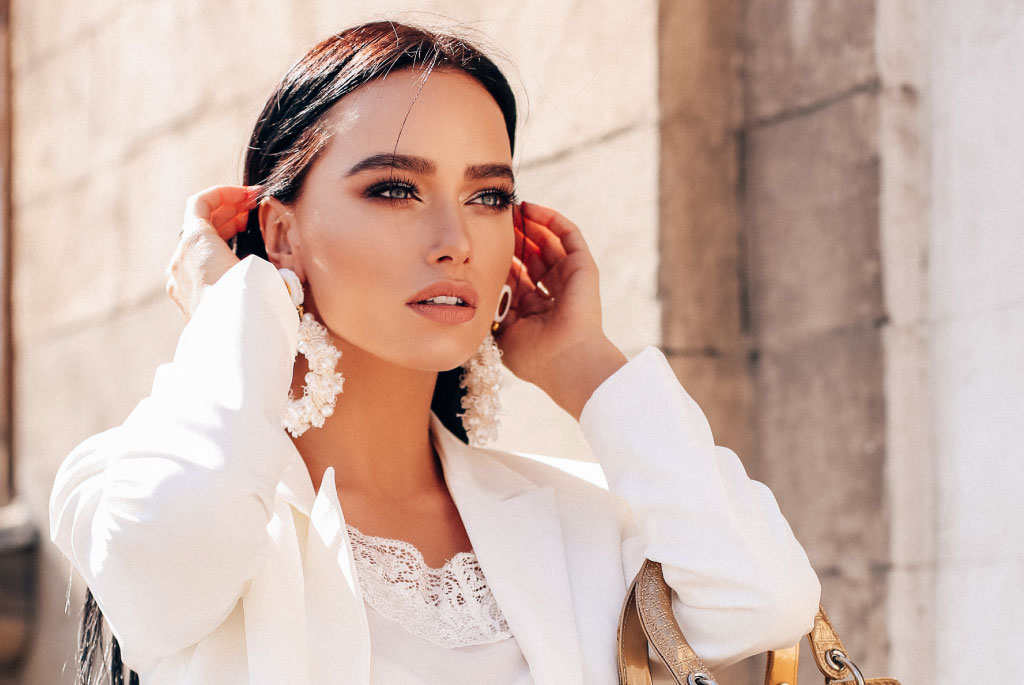 model for on the bright side cover magazine wearing white outfit with a white earrings
