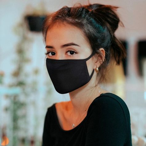 a woman wearing black face mask