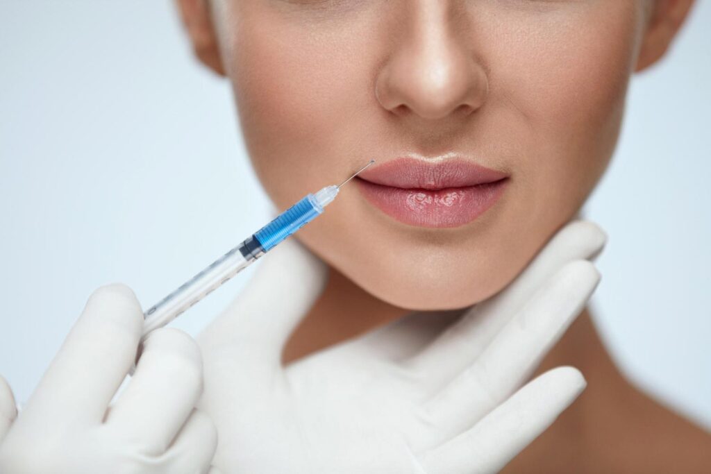 syringe about to be injected to the patient for lip filler