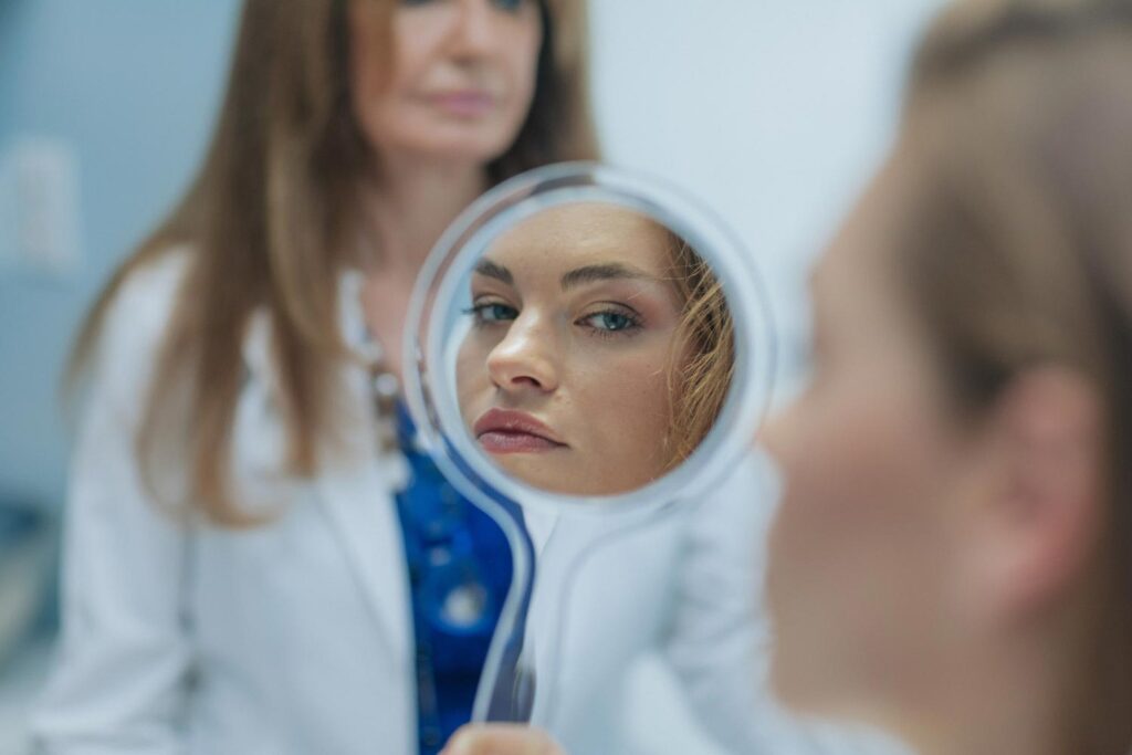 patient checking the result in a mirror after having wrinkle relaxers