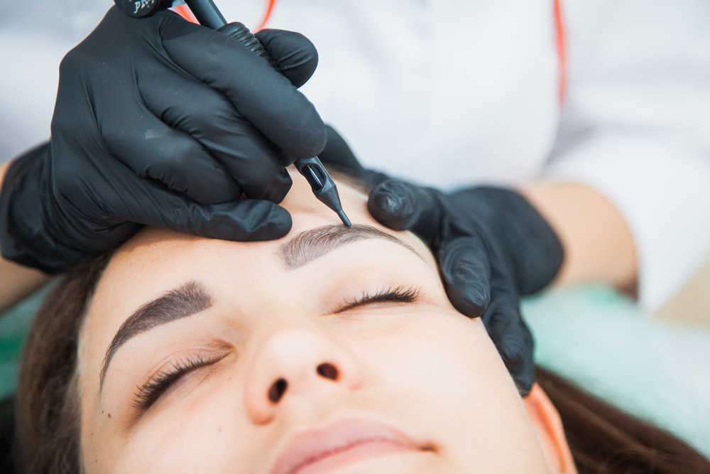 microshading techniques. woman relaxing while having eyebrows penciled on