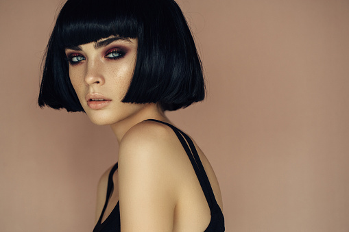 Beautiful woman with make-up and short black blunt haircut