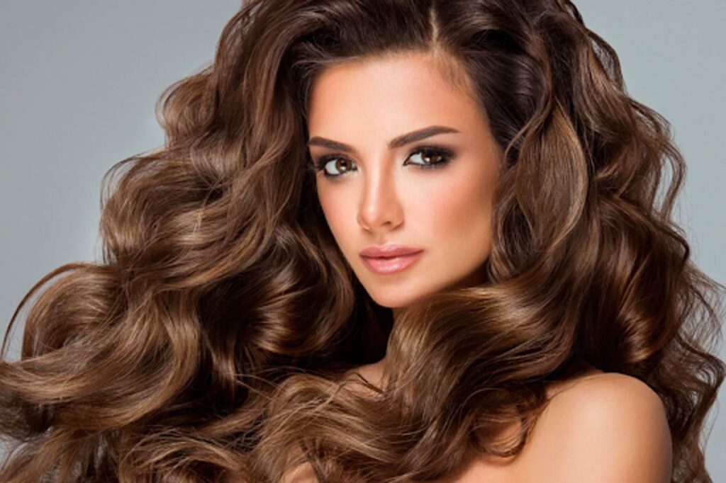 beautiful woman with long wavy and luscious flowing brown hair