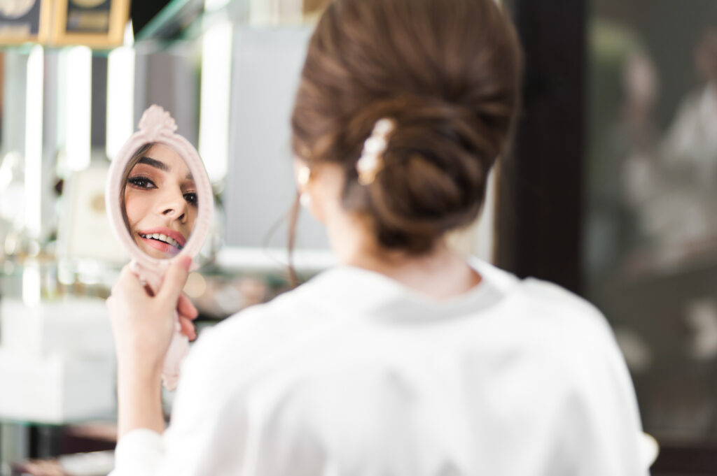 Client looking into mirror while admiring herself