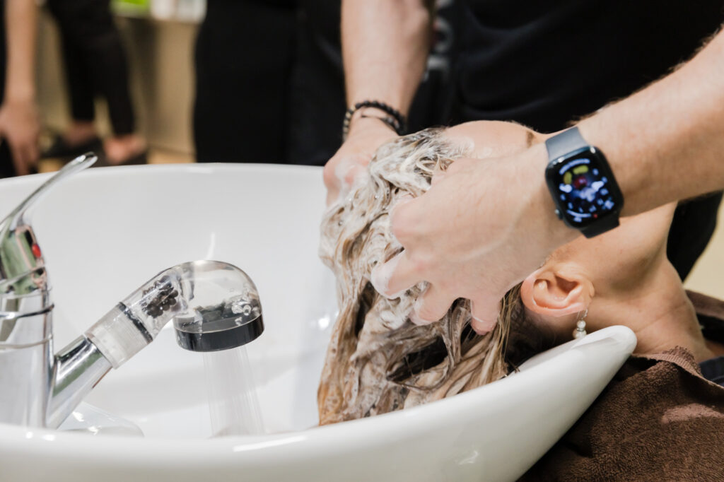 Close up of client getting hair wash at salon