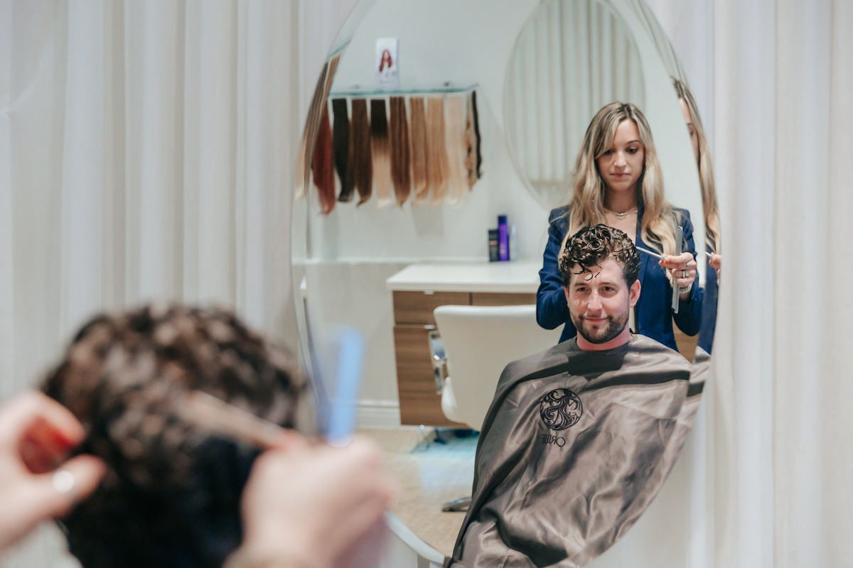 A man in his 30s enjoys hair styling at Anushka after successful hair loss treatments in West Palm Beach.