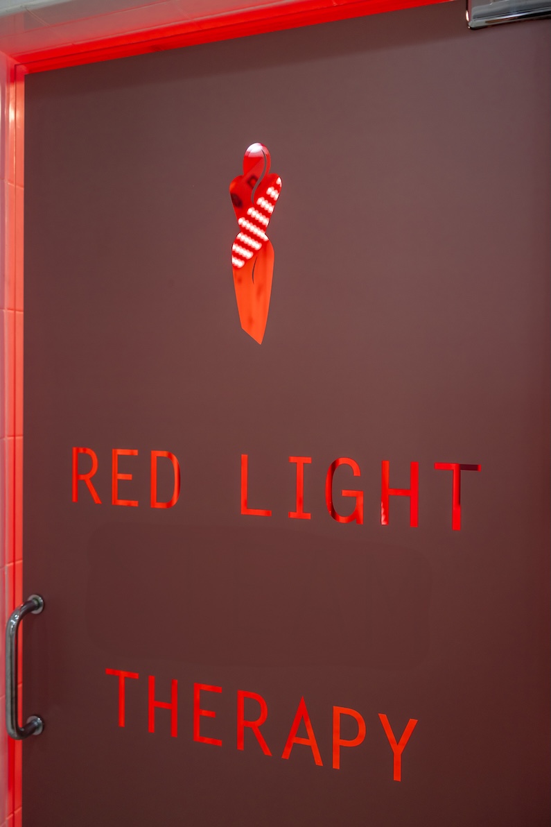 Red Light Therapy text on a closed, brown door